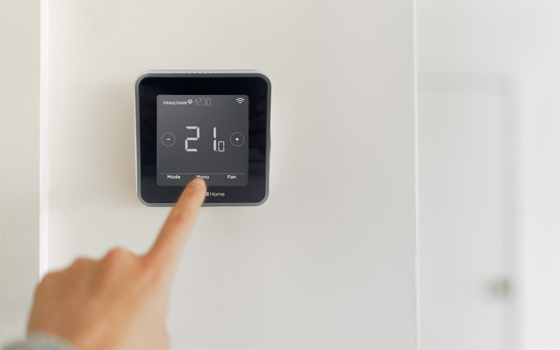 A finger adjusting the Honeywell Smart Thermostat.